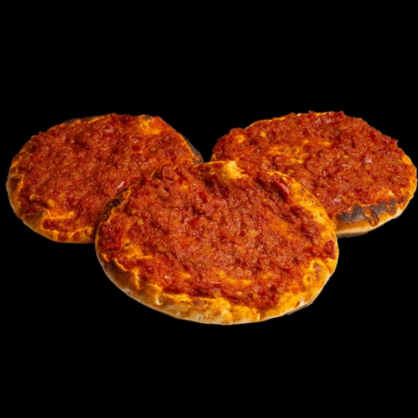 Three round Lebanese flatbreads, Manakish, topped with a vibrant red tomato and pepper mixture.